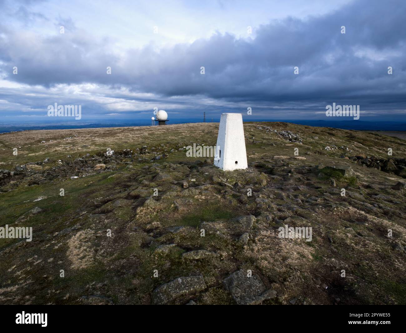 Air traffic and weather radar domes alongside the trig point on the