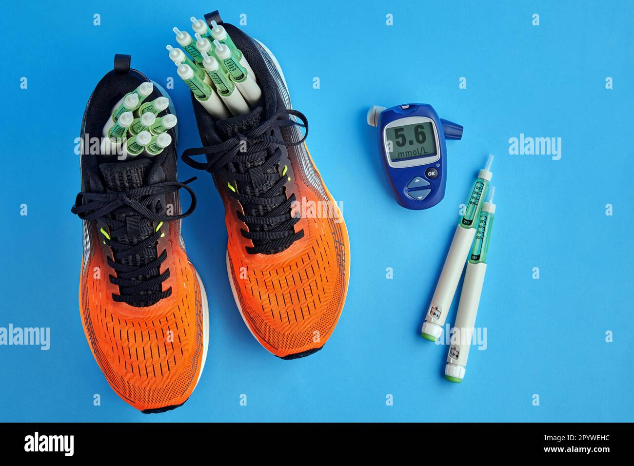 Orange running shoes with insulin syringe pens and a for
