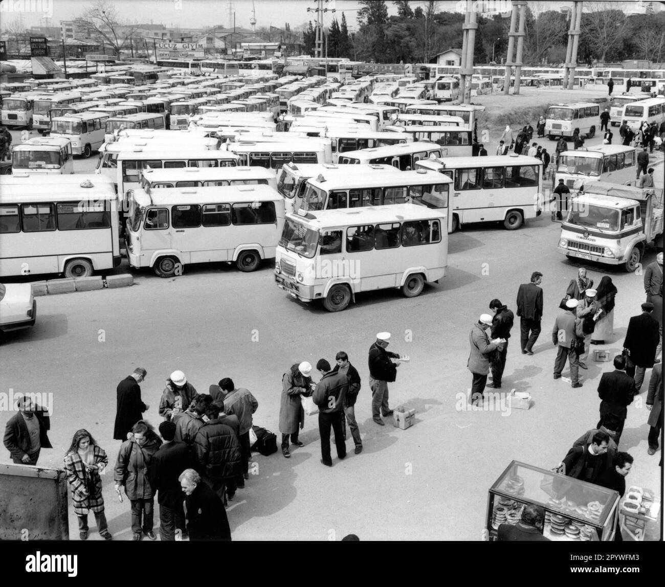 Istanbul (Turkey), Topkapi bus station. Buses and travelers, street scene: Parking lot with buses, travelers buy tickets and wait for departure. Black-and-white. Photo, 1994. Stock Photo