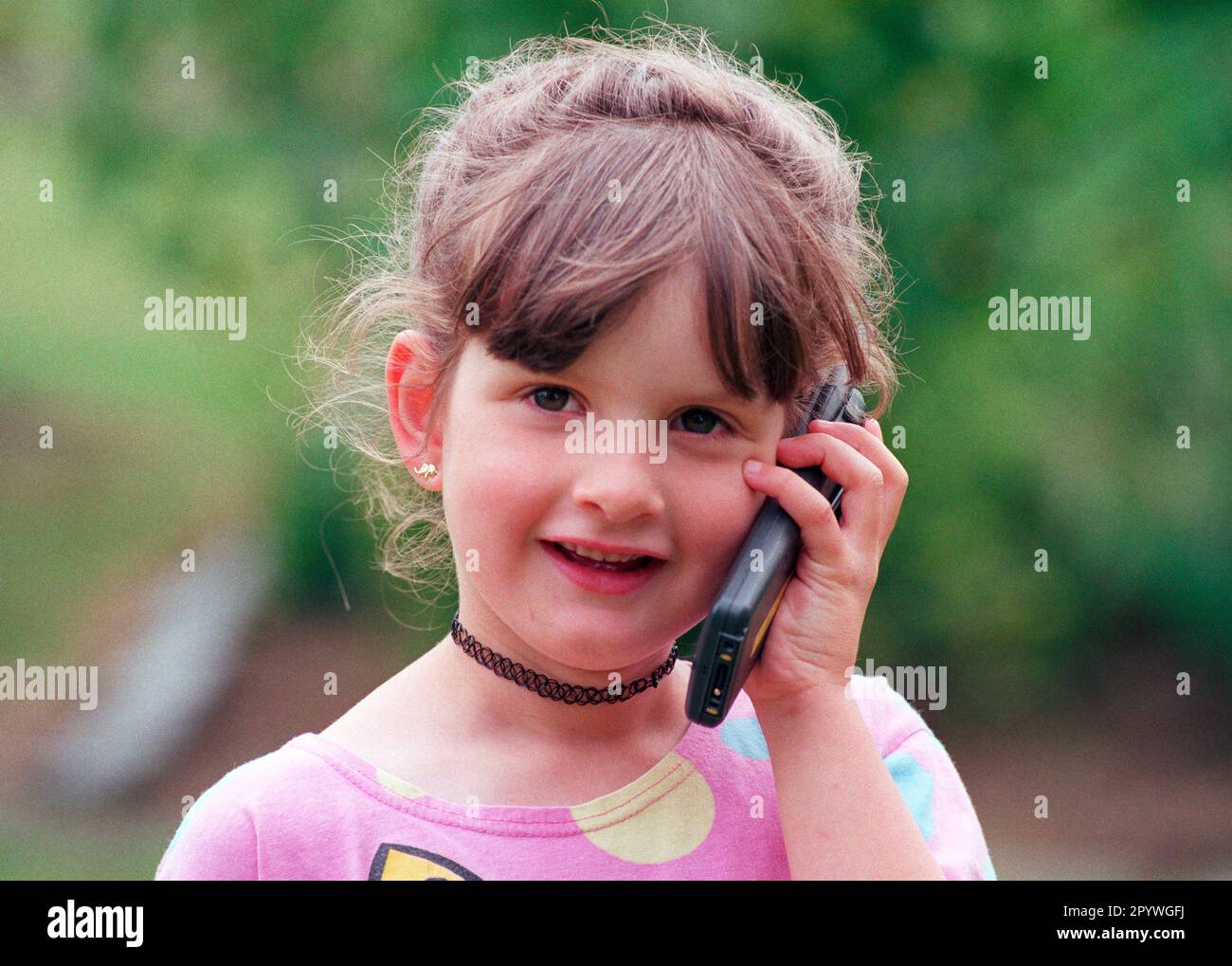 DEU , GERMANY : A girl is speaking into a mobile phone / cell phone , July 1999 Stock Photo