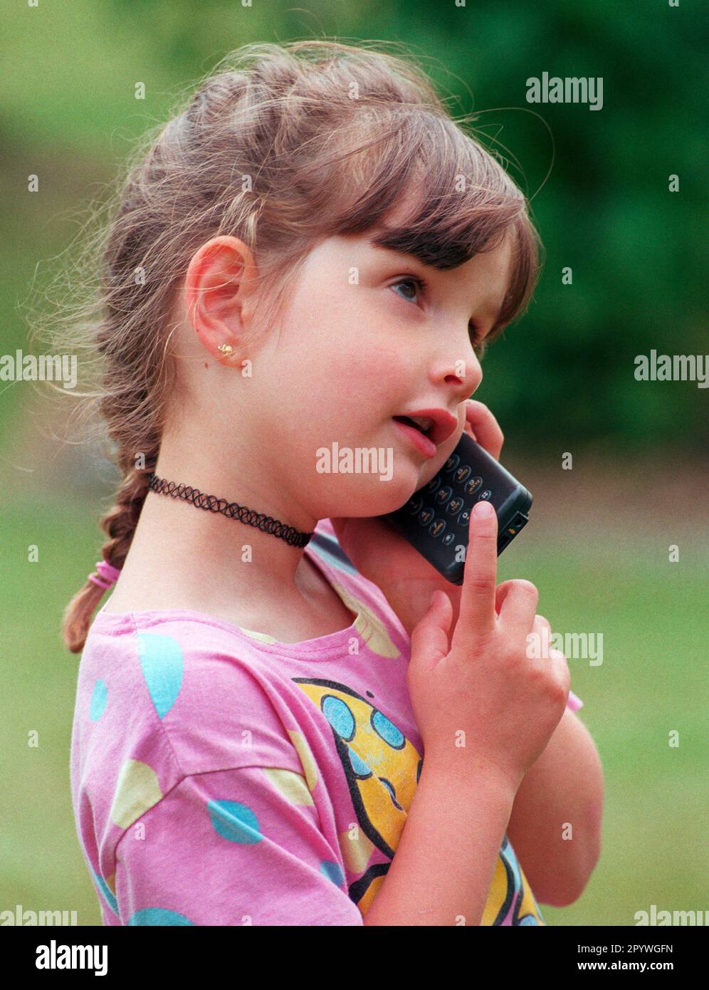 DEU , GERMANY : A girl is speaking into a mobile phone / cell phone , July 1999 Stock Photo
