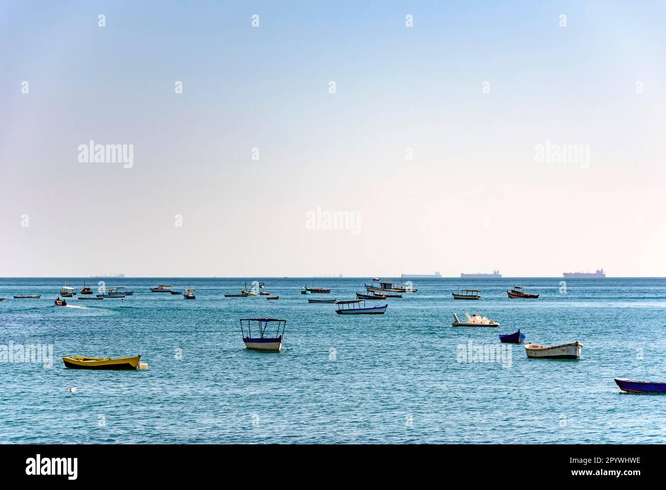 Evening at Todos os Santos bay in Salvador Bahia during a sunny summer day with its moored boats and the skyline, Brasil Stock Photo