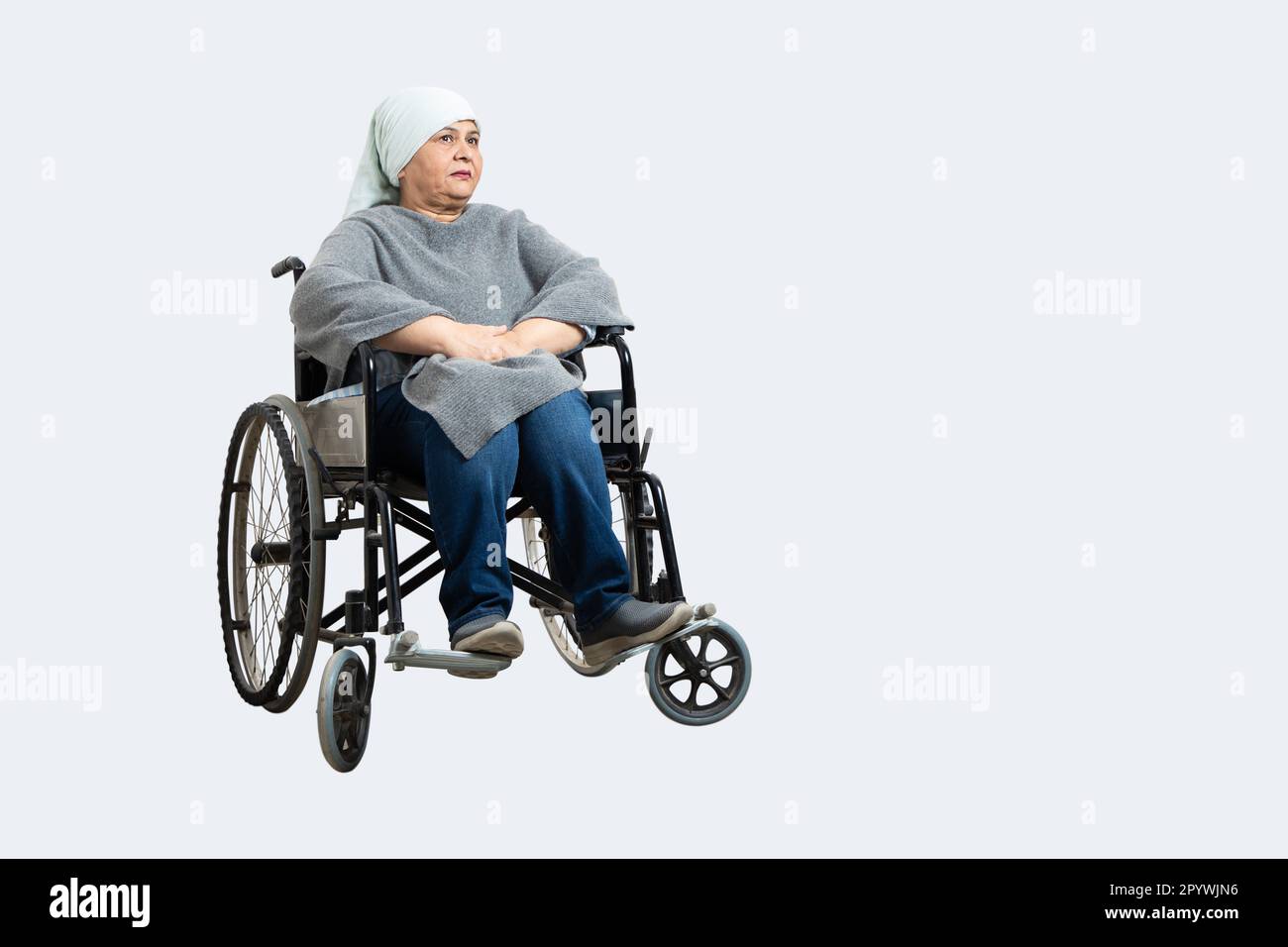 Senior indian woman cancer patient sitting on a wheelchair undergoing