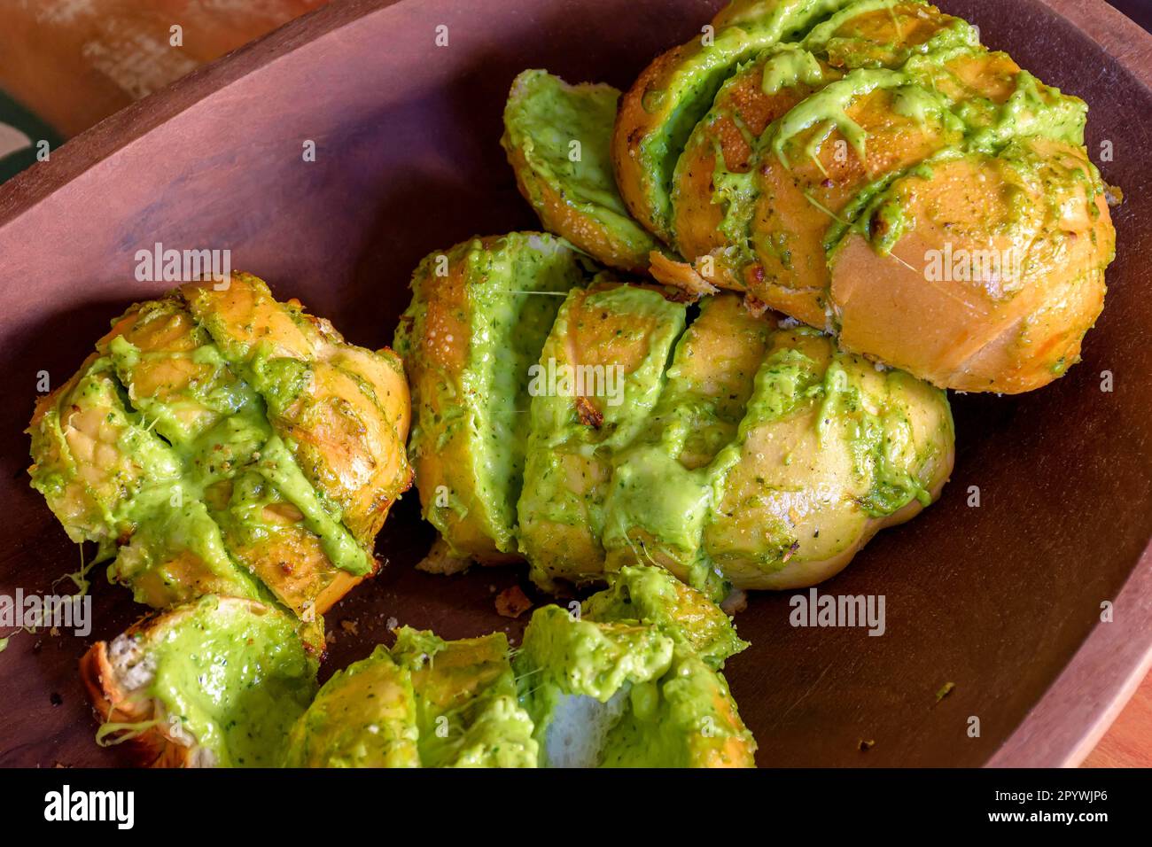 Garlic bread appetizer with melted cheese and fine aromatic herbs