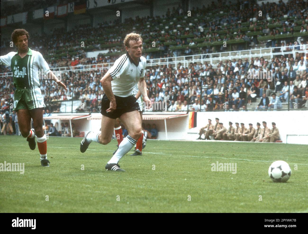 Soccer World Cup 1982 in Spain. Preliminary round: Algeria - Germany 2:1 / 16.06.1982 in Gijon. / Hans-Peter Briegel (GER) action in front of Lakhdar Belloumi (left). [automated translation] Stock Photo