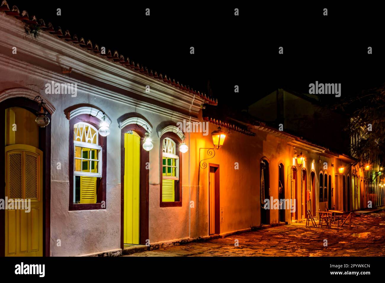 Stone street and colonial style houses illuminate at night in the city of Paraty on the coast of Rio de Janeiro, Brazil, Brasil Stock Photo