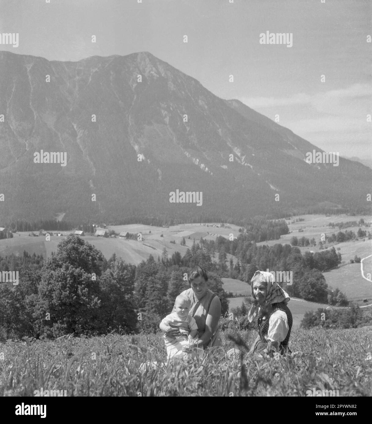 A peasant family in front of an alpine scenery in Styria Stock Photo