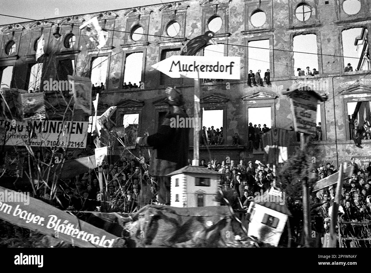 Carnival parade in Munich in front of a bombedout building front