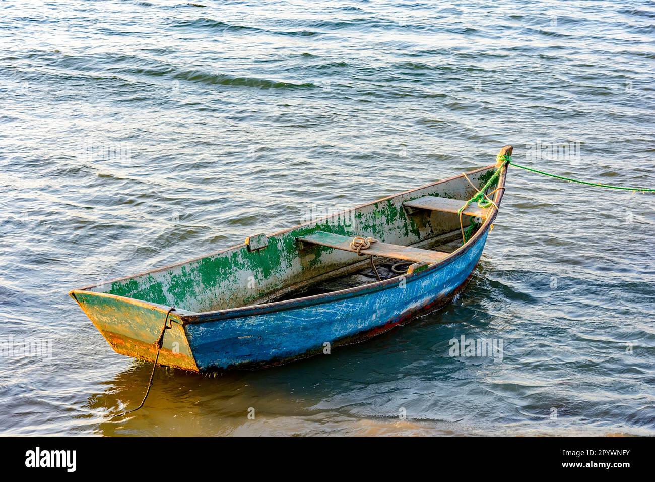 Old wooden fishing boat floating over sea, Buzios, Rio de Janeiro, Brasil Stock Photo