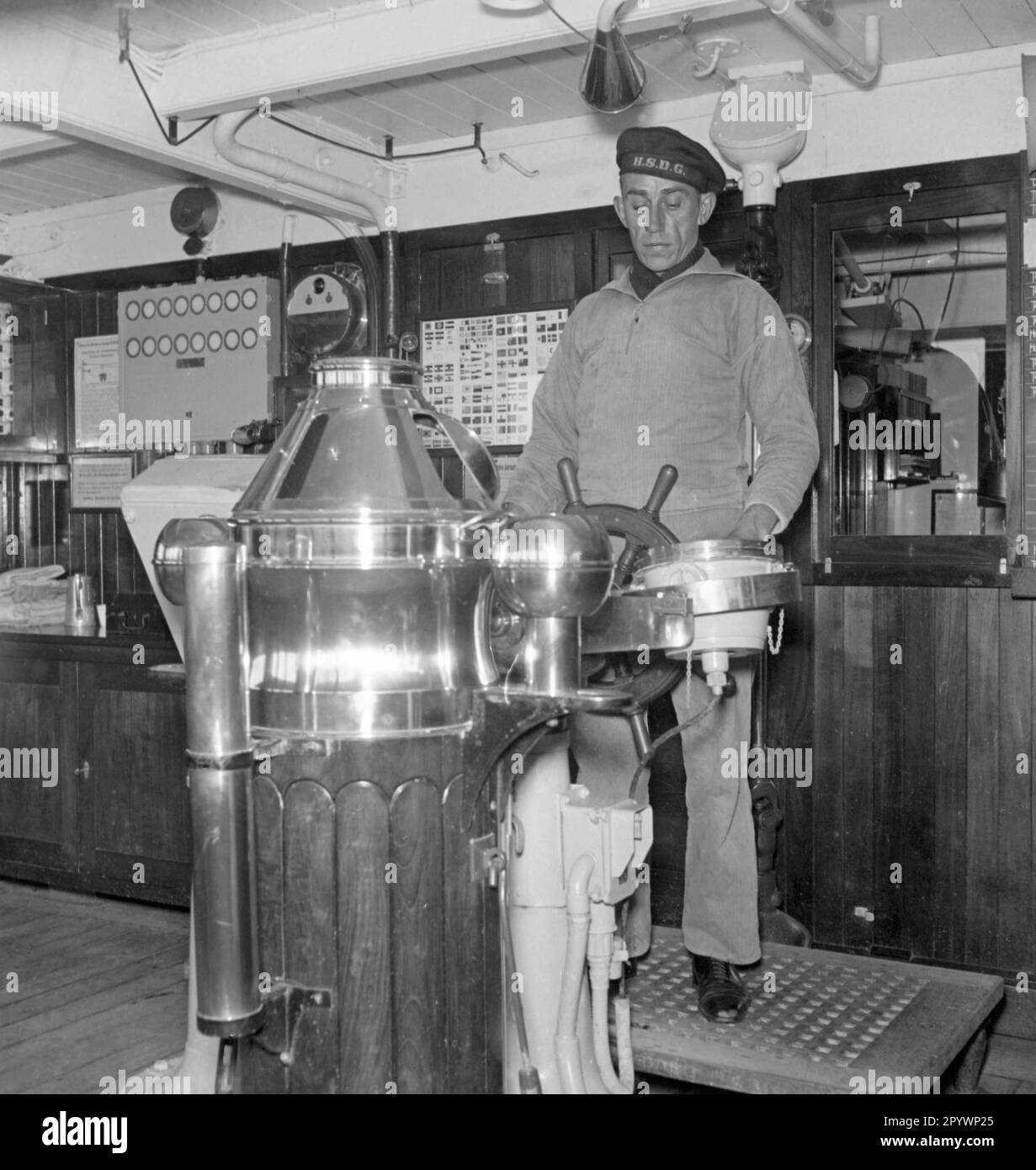 "A helmsman on the bridge of the ""Monte Rosa"" of Hamburg Sued in the