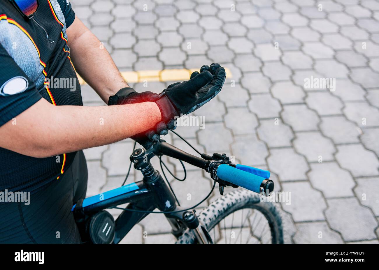 Cyclist man with hand pain outdoors. Close up of cyclist with arthritis ...
