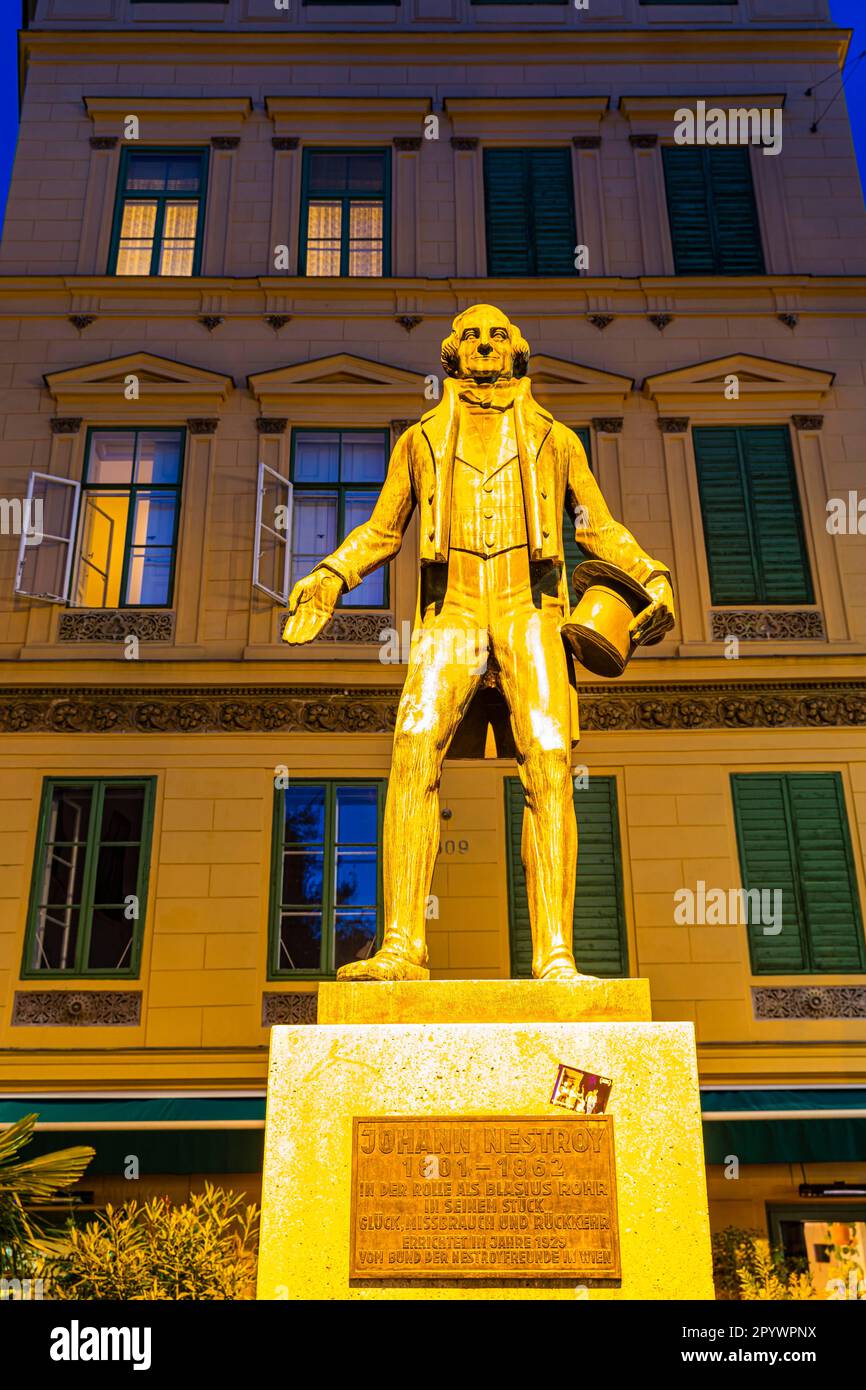 The illuminated monument of Johann Nestroy, night shot, Leopoldstadt, Vienna, Austria Stock Photo