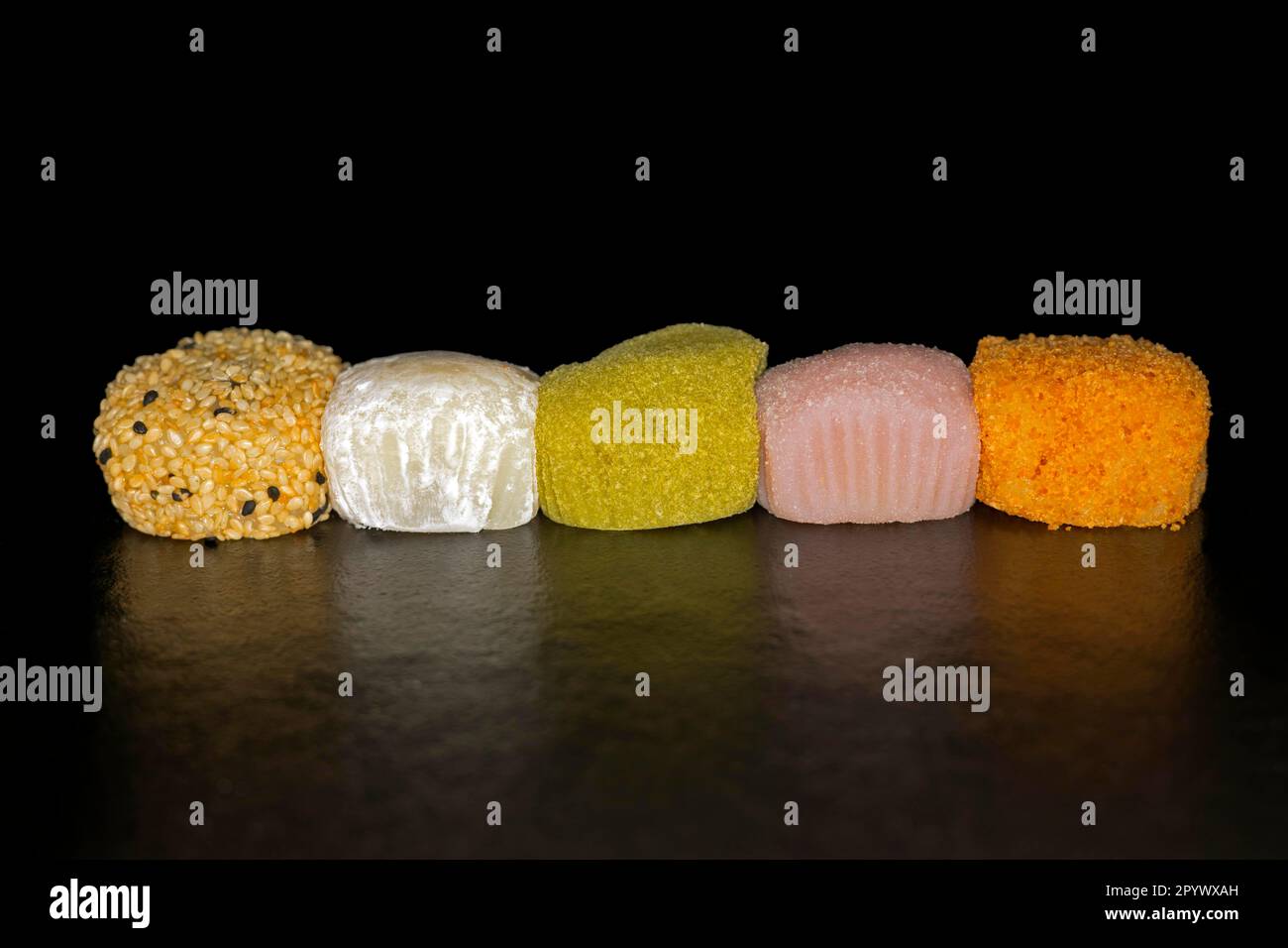 Five differently filled Japanese Mochi's, rice flour cake, food photography with black