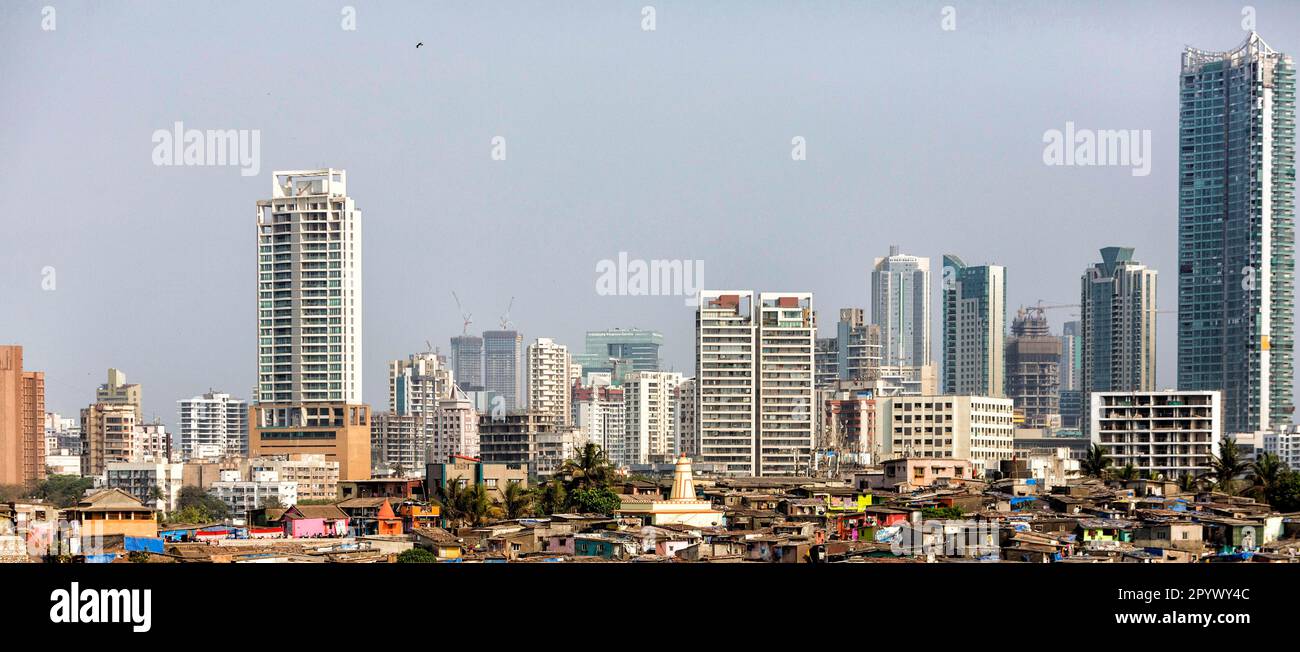 Modern skyline with skyscrapers, in front the corrugated iron huts of a slum, Mumbai, India Stock Photo