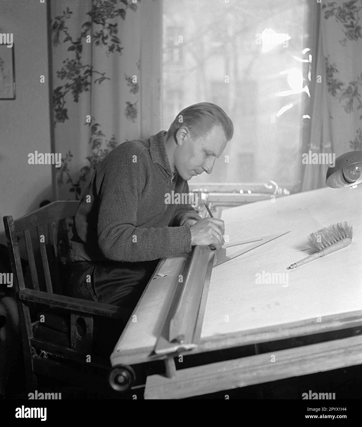 "Man at a drawing board. Scene from the series ""We work together