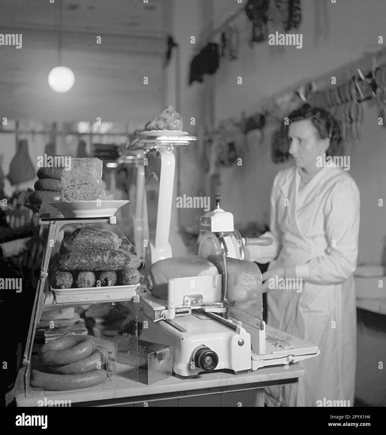 "A woman prepares goods for sale. Scene from the series ""We work