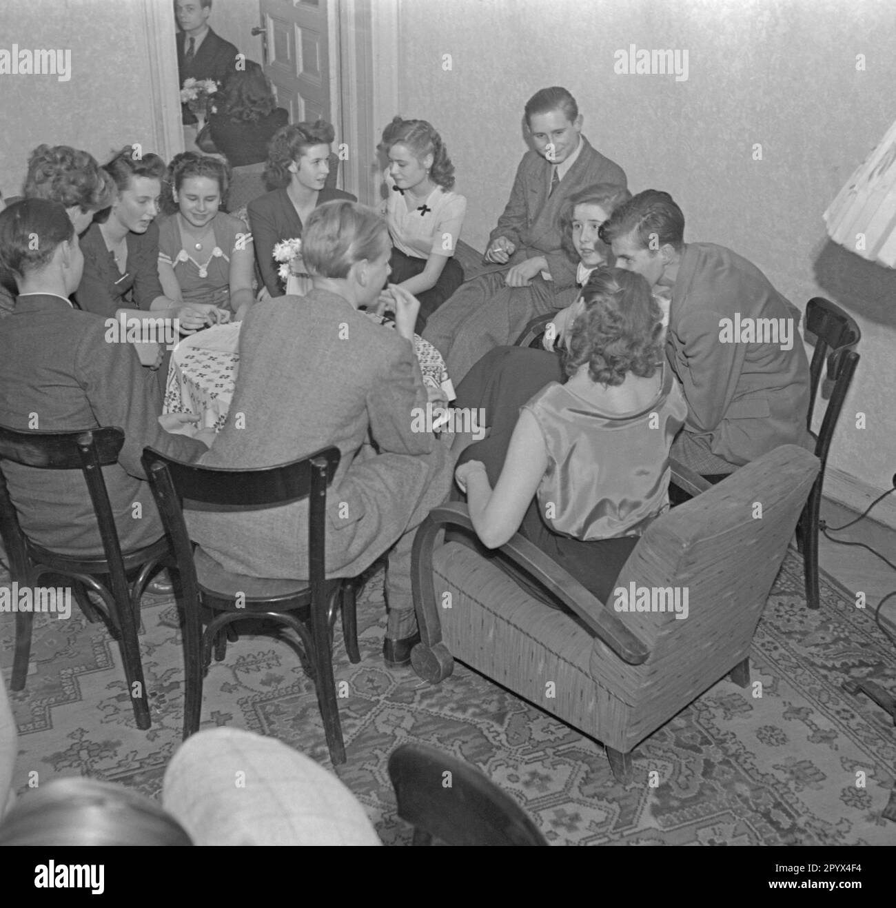 The picture shows a dance class in a dance school in Berlin. Men and women having a conversation