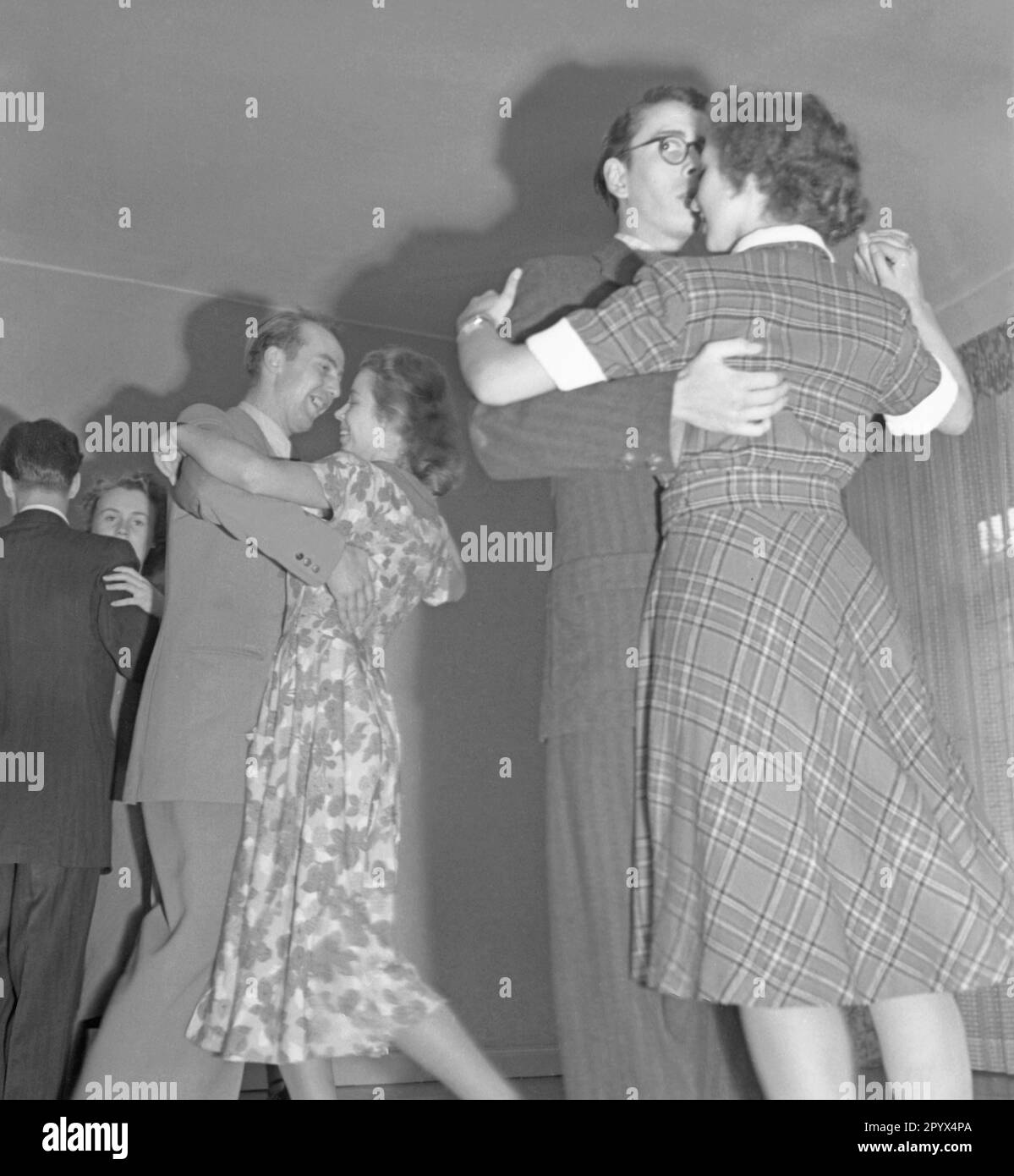 Several couples dancing at a ball. Undated picture, probably from the year 1950. Stock Photo