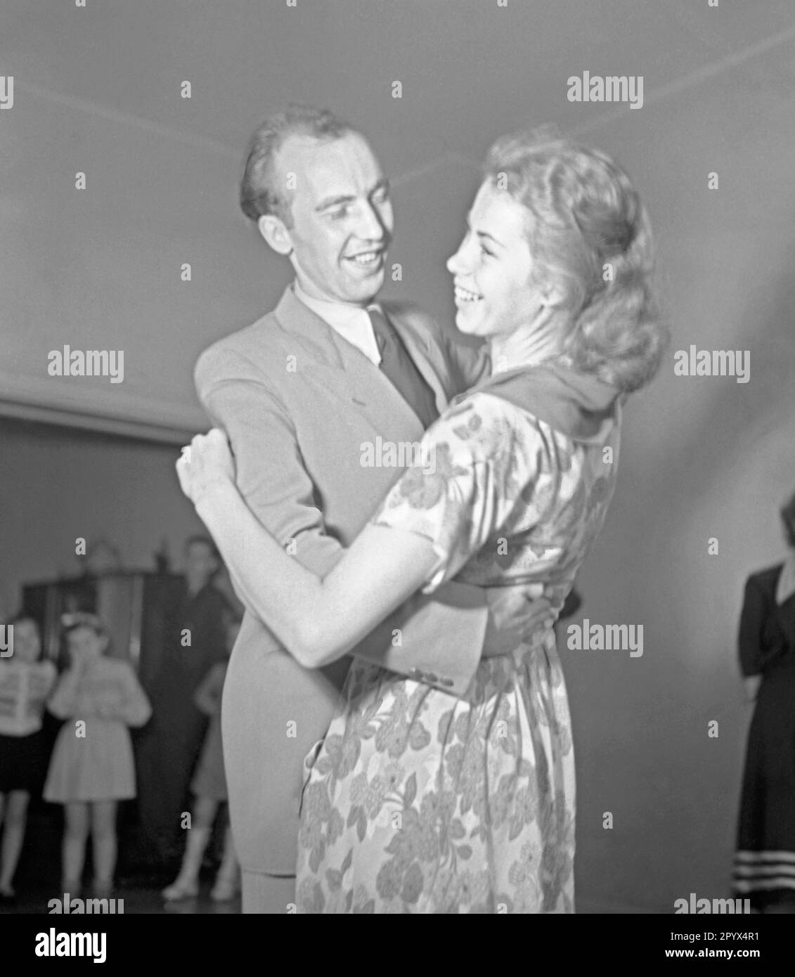 A man is dancing with a woman. Undated picture, probably from the year 1950. Stock Photo