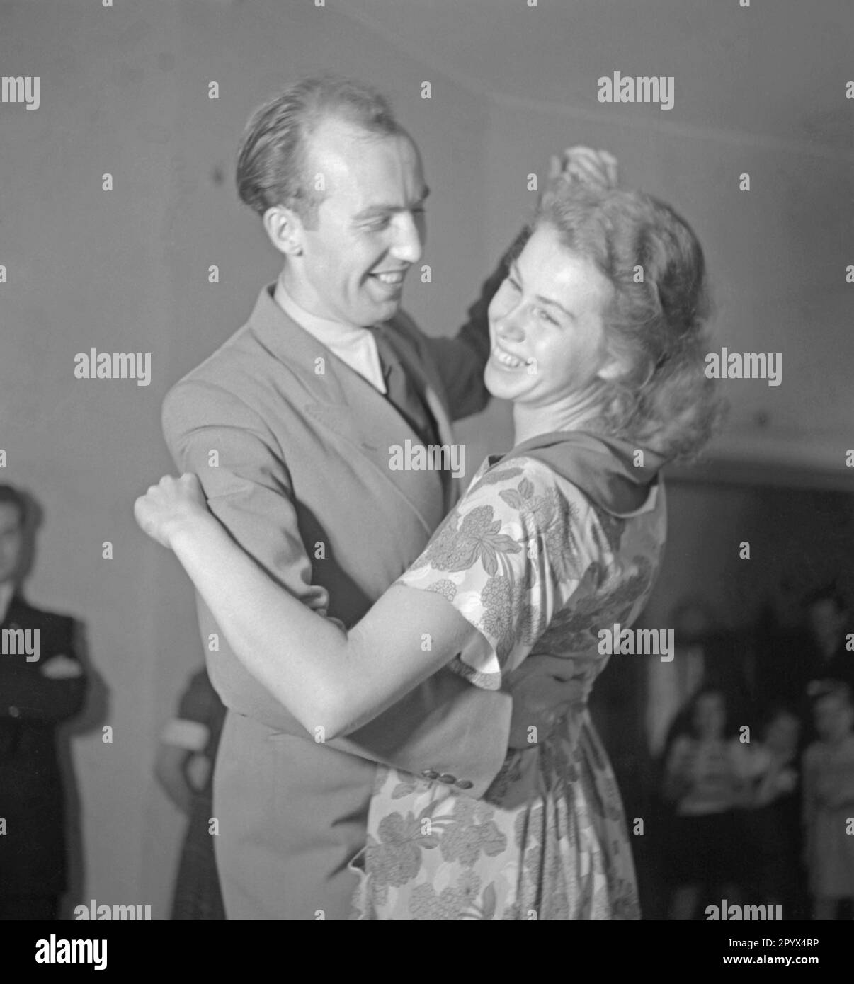 A man is dancing with a woman. Undated picture, probably from the year 1950. Stock Photo