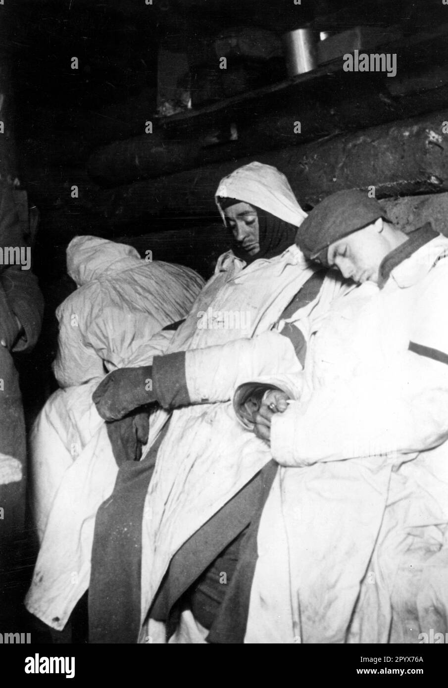 German soldiers sleep exhausted in their dugout on the Eastern Front