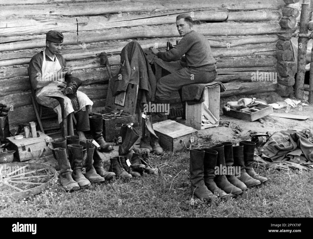Shoemakers and tailors mending the clothing of soldiers in an infantry company during the advance on the Eastern Front. Photo: Scheunemann [automated translation] Stock Photo