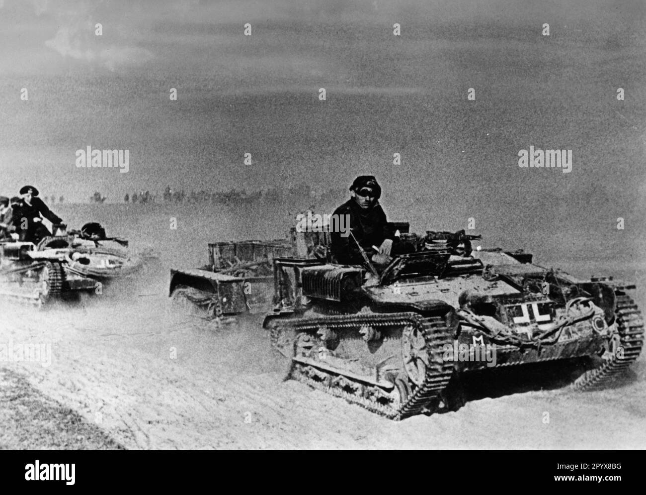 German troops on the advance on a road on the Eastern Front. These are tank chassis from war booty. Photo: Ketelhohn [automated translation] Stock Photo