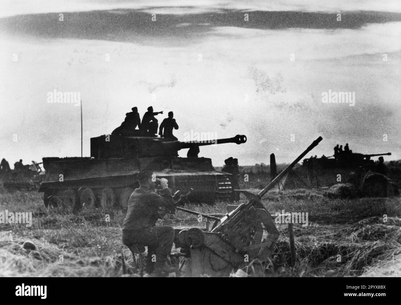 Panzer VI Tiger on the Eastern Front. In the foreground a 2cm anti-aircraft gun to protect against attacks by the Russian air force. Stock Photo