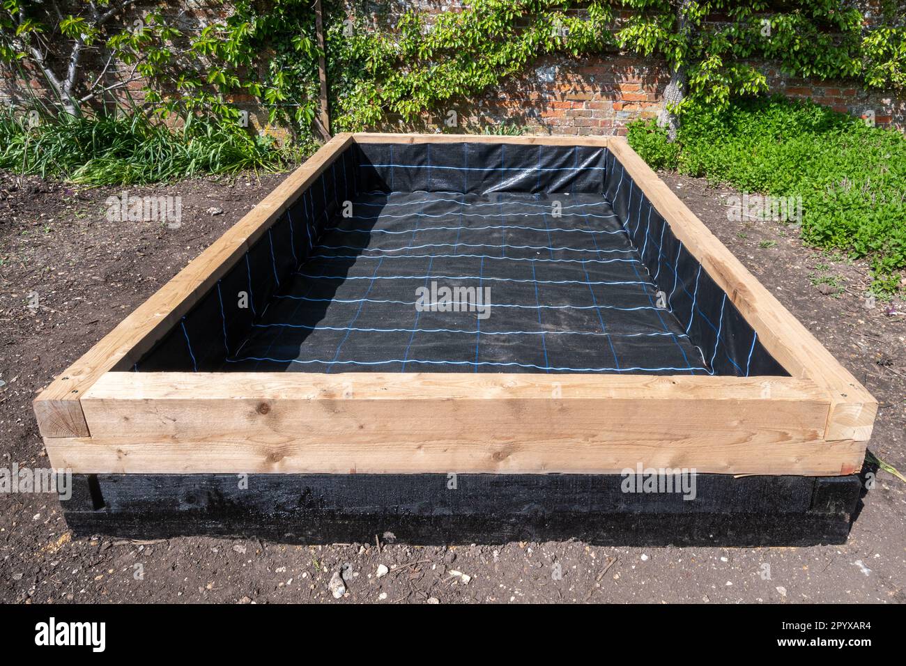 Making a raised bed for growing flowers or vegetables in a garden