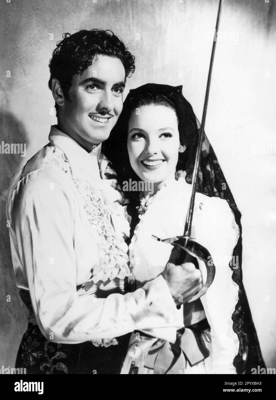 Tyrone Power as Don Diego with saber and Linda Darnell as Lolita in the movie 'Under the Sign of Zorro' . [automated translation] Stock Photo