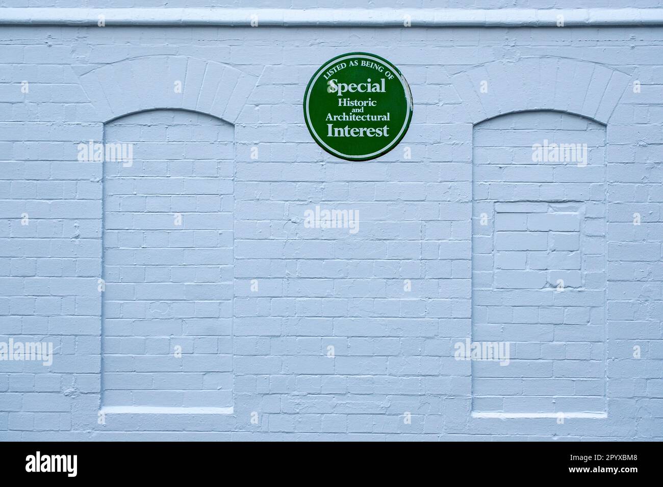 Green plaque; Listed as being of special historic and architectural interest on outside wall at Lyceum Theatre in Crewe Cheshire UK Stock Photo