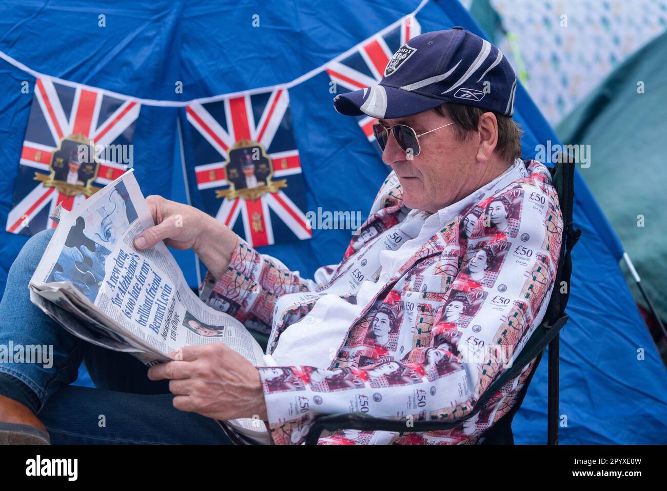 London UK. 5 May 2023. A royal fan wearing a jacket printed with bank notes. Thousands of royal fans Thousands of royal fans  fill the Mall decked in colourful union jack costumes to watch the royal procession with less than 24 hours  until the  first coronation for 70 years.. Credit: amer ghazzal/Alamy Live News Stock Photo