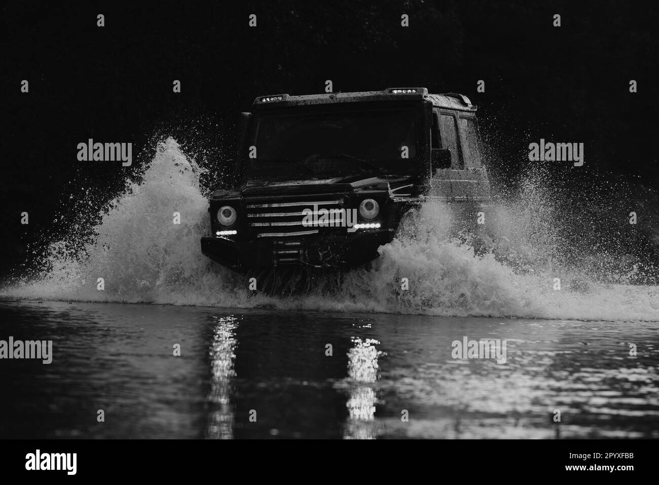 Mud and water splash in offroad racing. Expedition offroader. Drag
