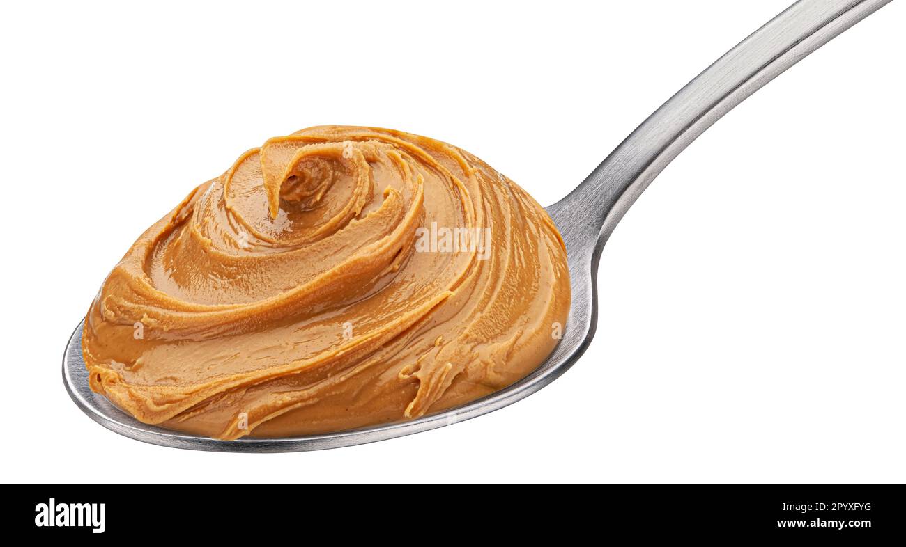 Caramel cream, boiled condensed milk swirl in spoon isolated Stock