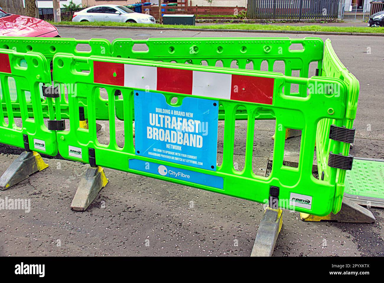 ultrafast broadband roadworks roadworks as street is dug up green barriers Stock Photo