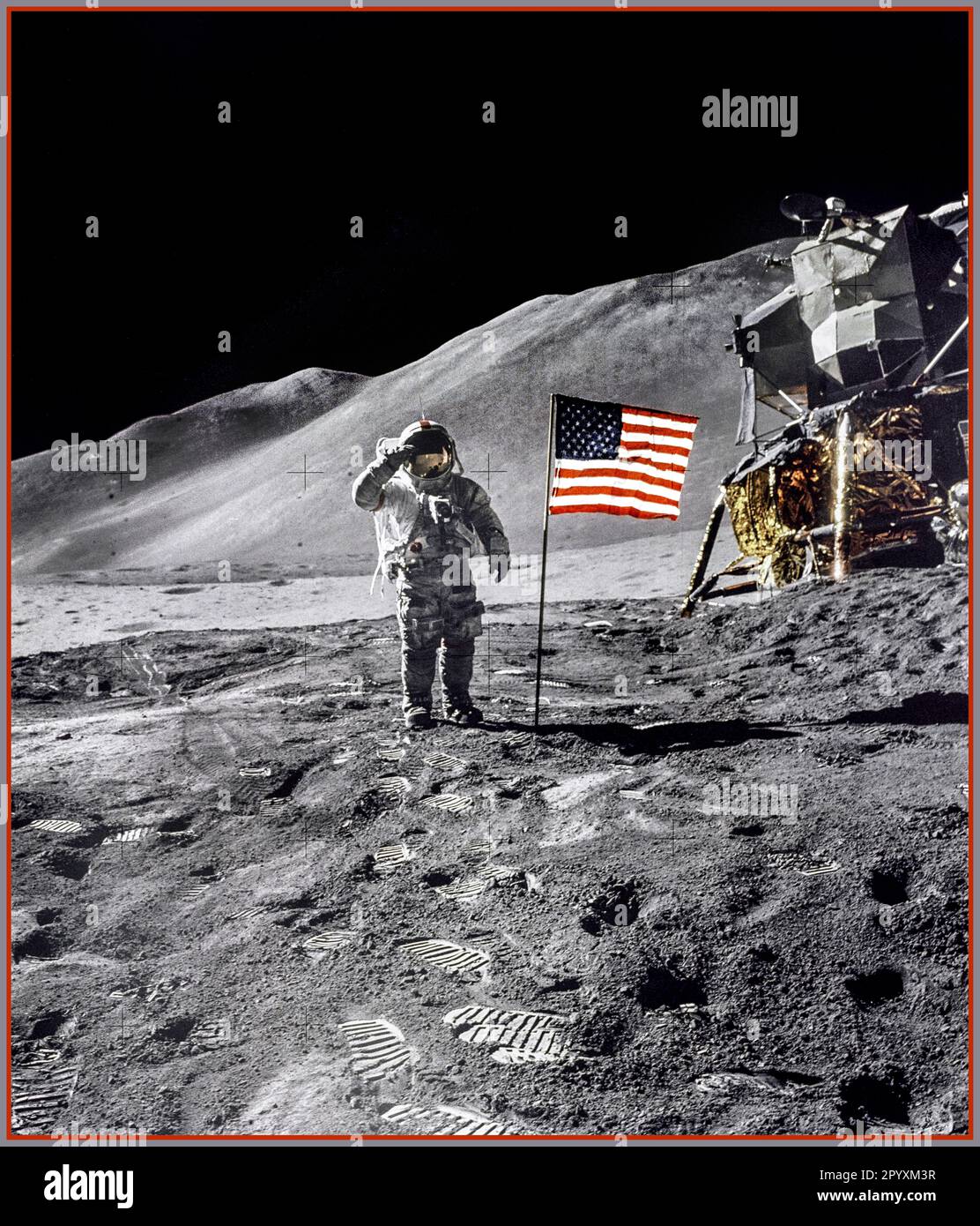 ON THE MOON Astronaut David R. Scott, commander, gives a military salute while standing beside the deployed U.S. flag during the Apollo 15 lunar surface extravehicular activity (EVA) at the Hadley-Apennine landing site. The flag was deployed toward the end of EVA-2. The Lunar Module 'Falcon' is partially visible on the right. Hadley Delta in the background rises approximately 4,000 meters (about 13,124 feet) above the plain. The base of the mountain is approximately 5 kilometers (about 3 statute miles) away. This photograph was taken by Astronaut James B. Irwin, Lunar Module pilot. Stock Photo