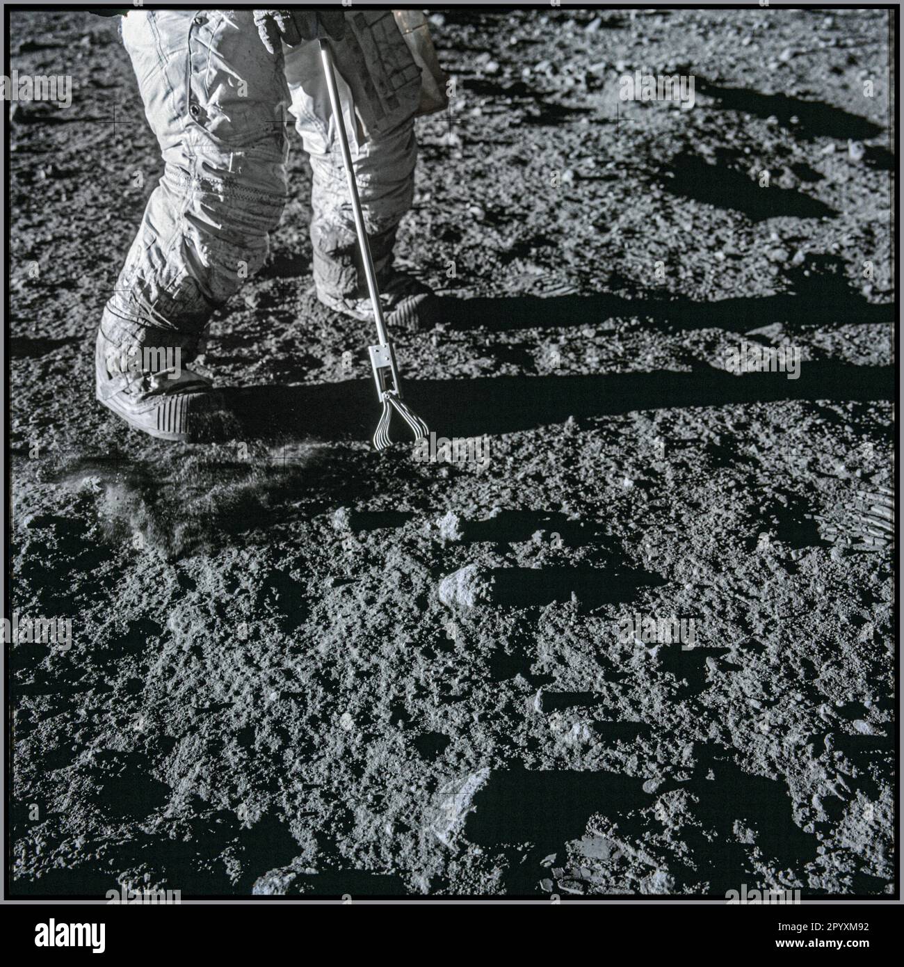 Close-up view of a set of tongs, an Apollo Lunar Hand Tool, being used by Astronaut Charles Conrad Jr., to pick up lunar samples during the Apollo XII mission, November 19, 1969. Date 19 November 1969 Stock Photo