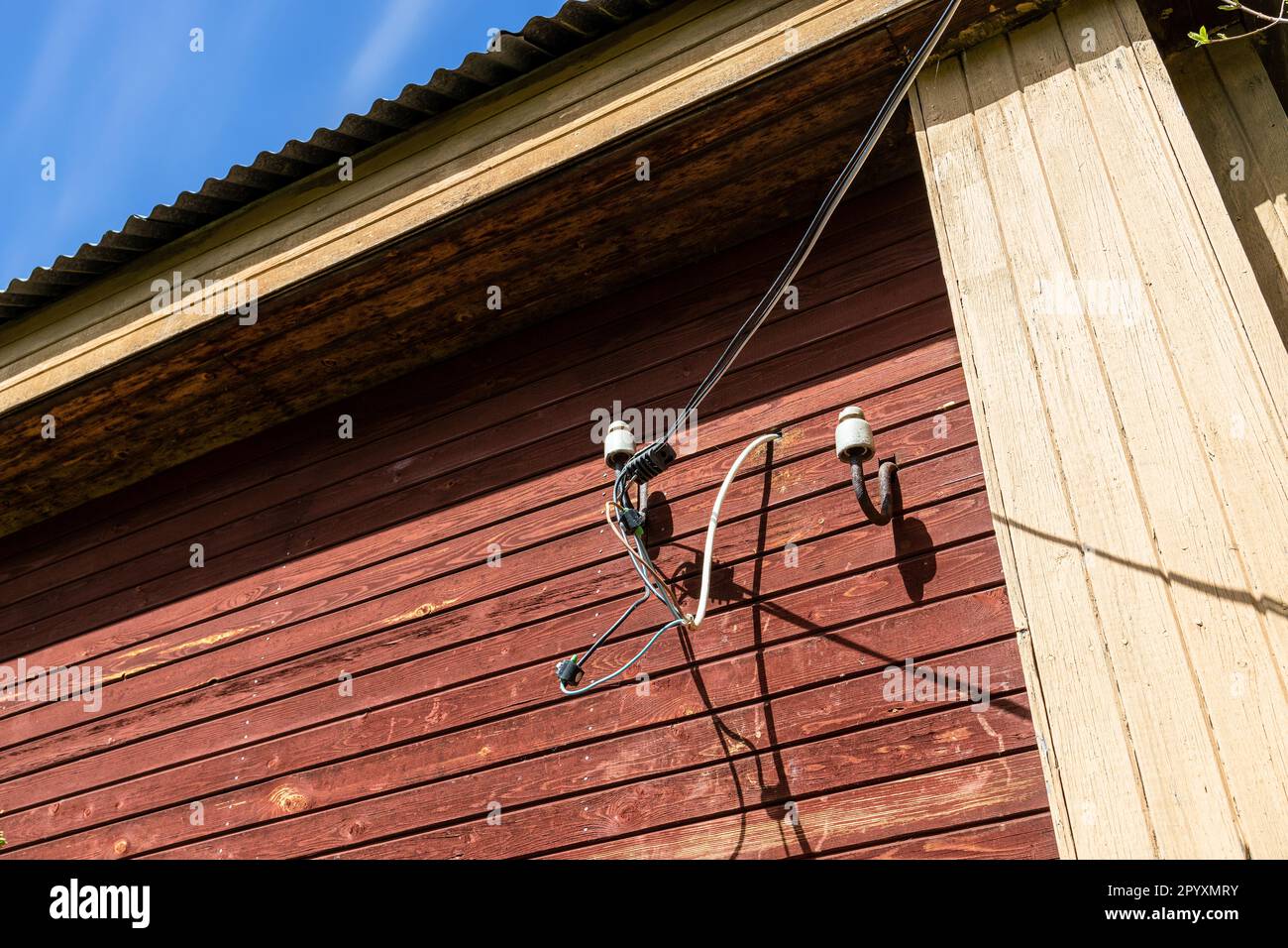 homemade outdoor wiring of electrical wires to wooden village house