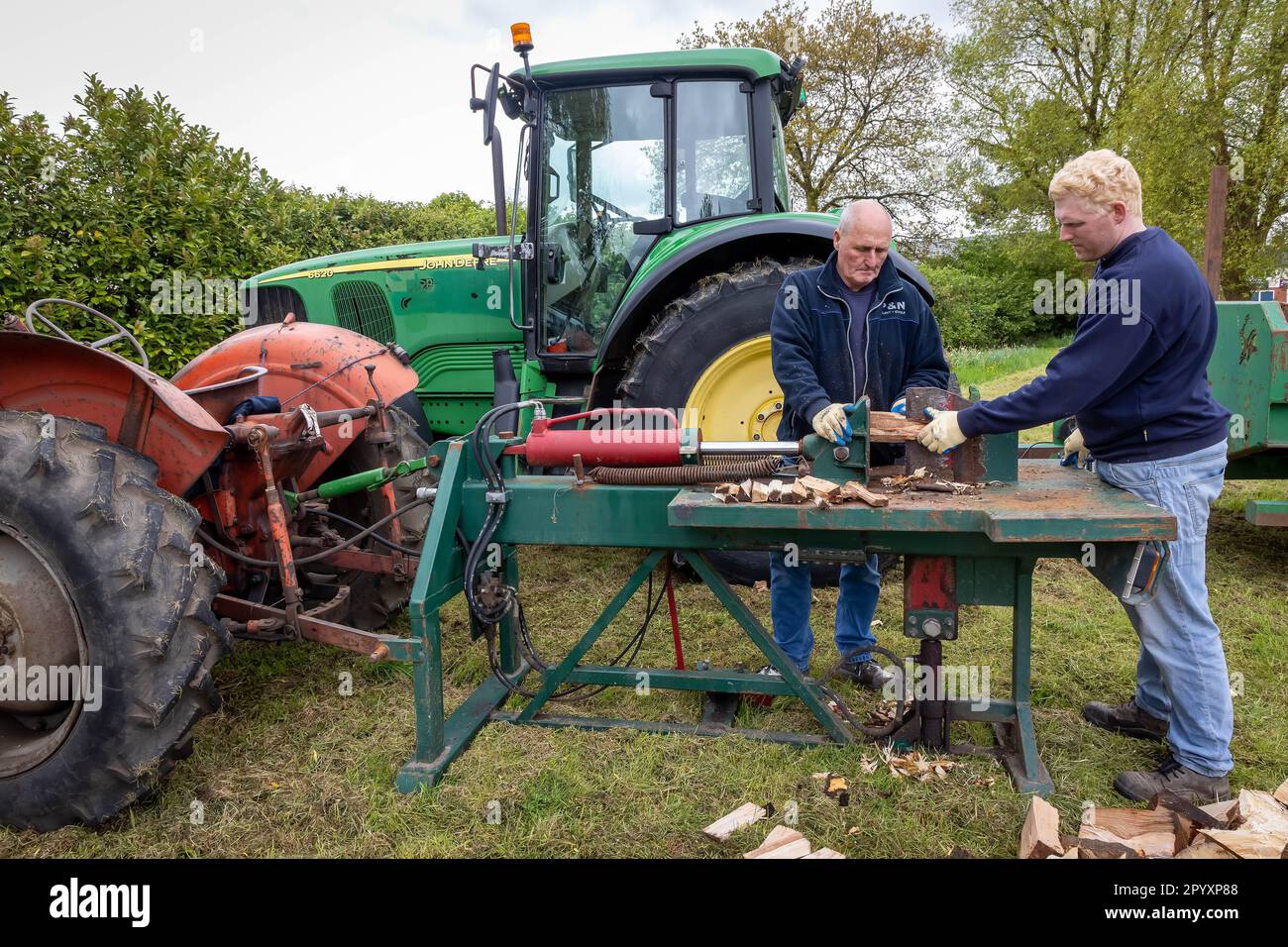 Demonstration of a tractor driven hydraulic log splitter at the 2023 Culcheth and Glazebury Community Day on the village green Stock Photo