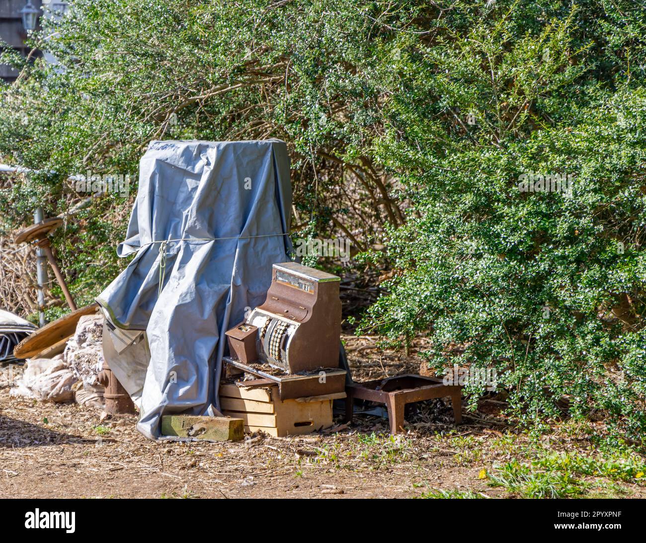 an old selection of old items piled in a yard Stock Photo