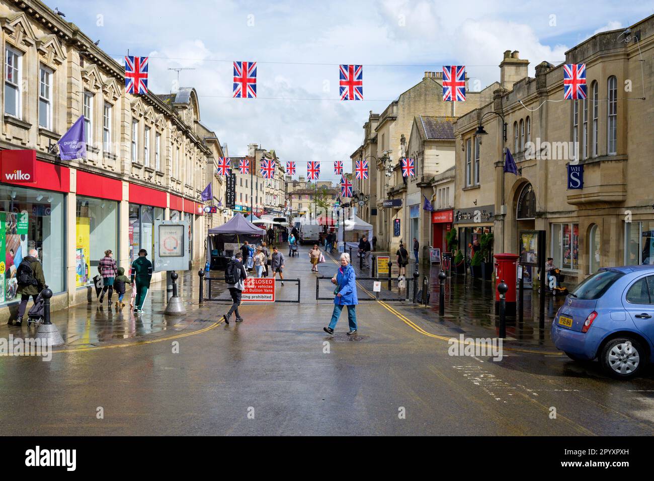 Chippenham, Wiltshire, UK. 5th May, 2023. Union flags are pictured flying in Chippenham high street ahead of the Coronation of King Charles III. With weather forecasters predicting heavy rain showers on the morning of the coronation, Chippenham Town council have been forced to move their planned outdoor screening of the coronation indoors because of the predicted bad weather.  Credit: Lynchpics/Alamy Live News Stock Photo