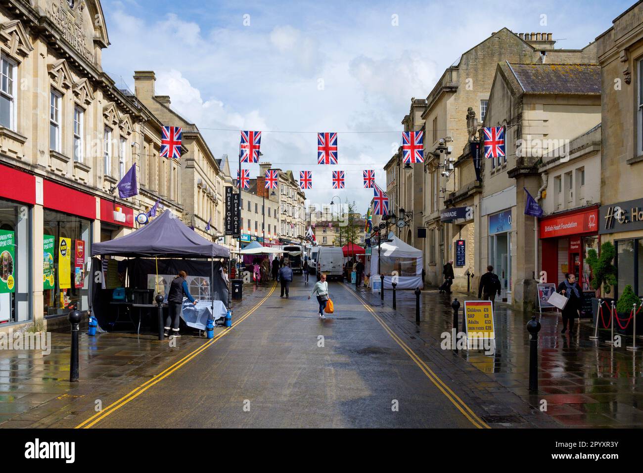 Chippenham, Wiltshire, UK. 5th May, 2023. Union flags are pictured flying in Chippenham high street ahead of the Coronation of King Charles III. With weather forecasters predicting heavy rain showers on the morning of the coronation, Chippenham Town council have been forced to move their planned outdoor screening of the coronation indoors because of the predicted bad weather.  Credit: Lynchpics/Alamy Live News Stock Photo
