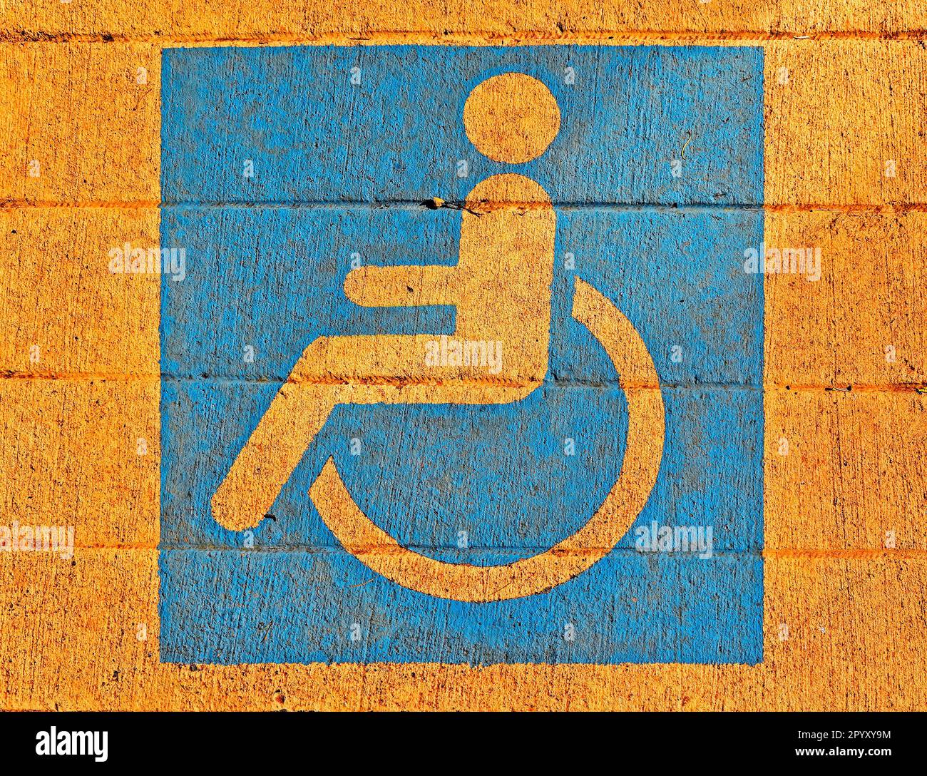 Wheelchair pictogram painted on sidewalk Stock Photo