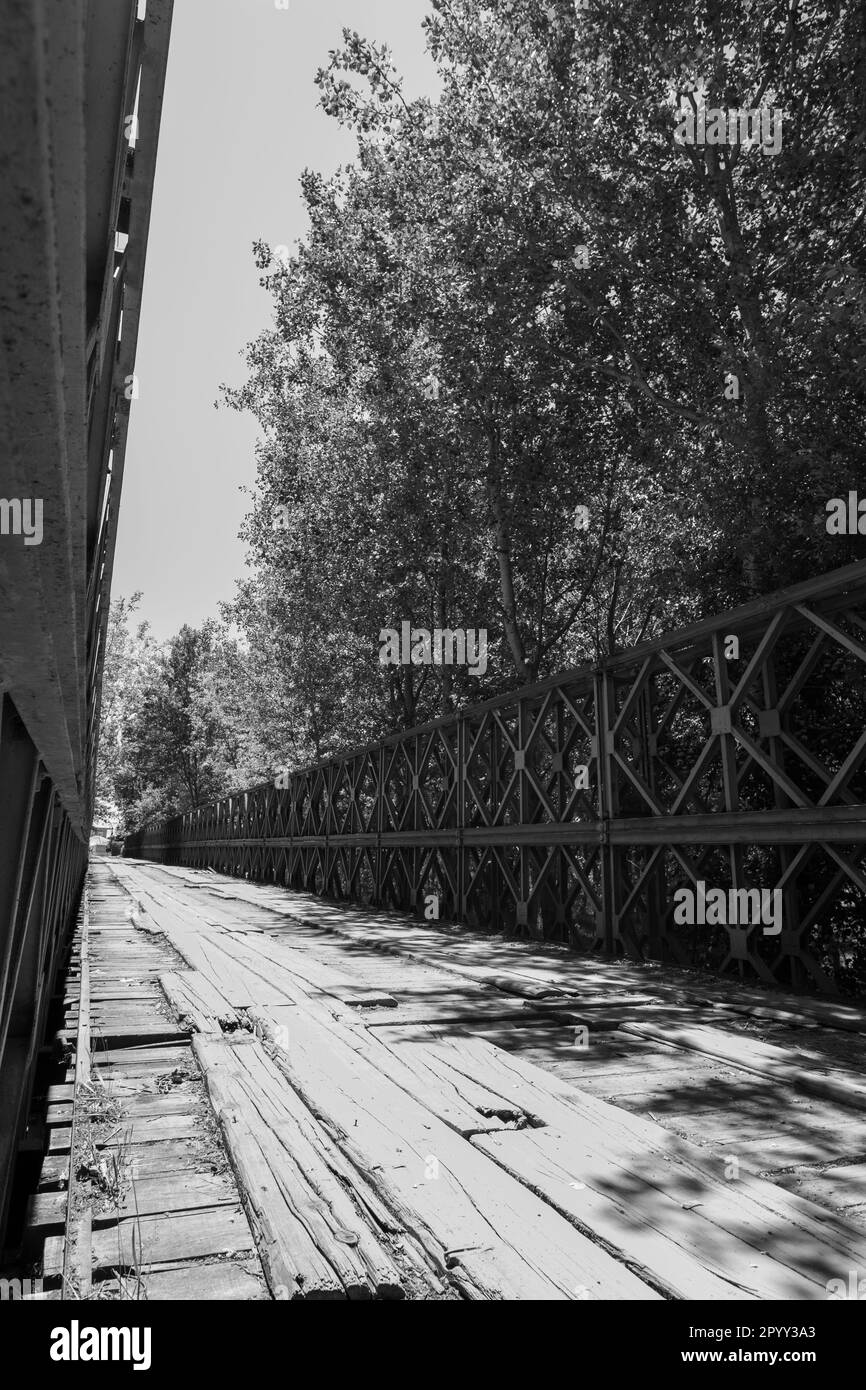 Timeworn and timeless An old bridge with wooden planks and iron