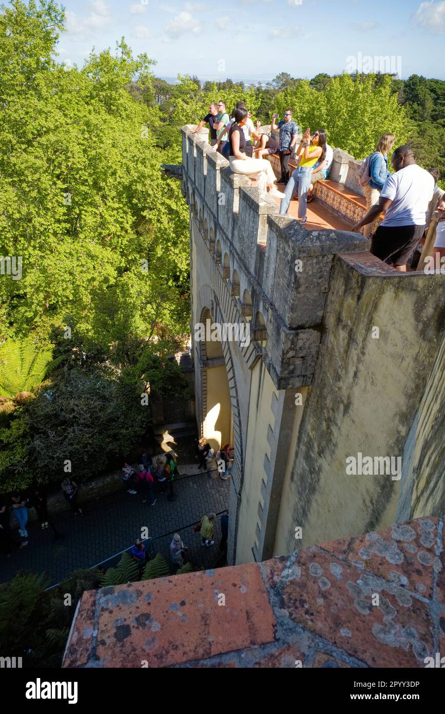 Visitors to the Pena Palace in Sintra pose for photos high above the queue to enter Stock Photo
