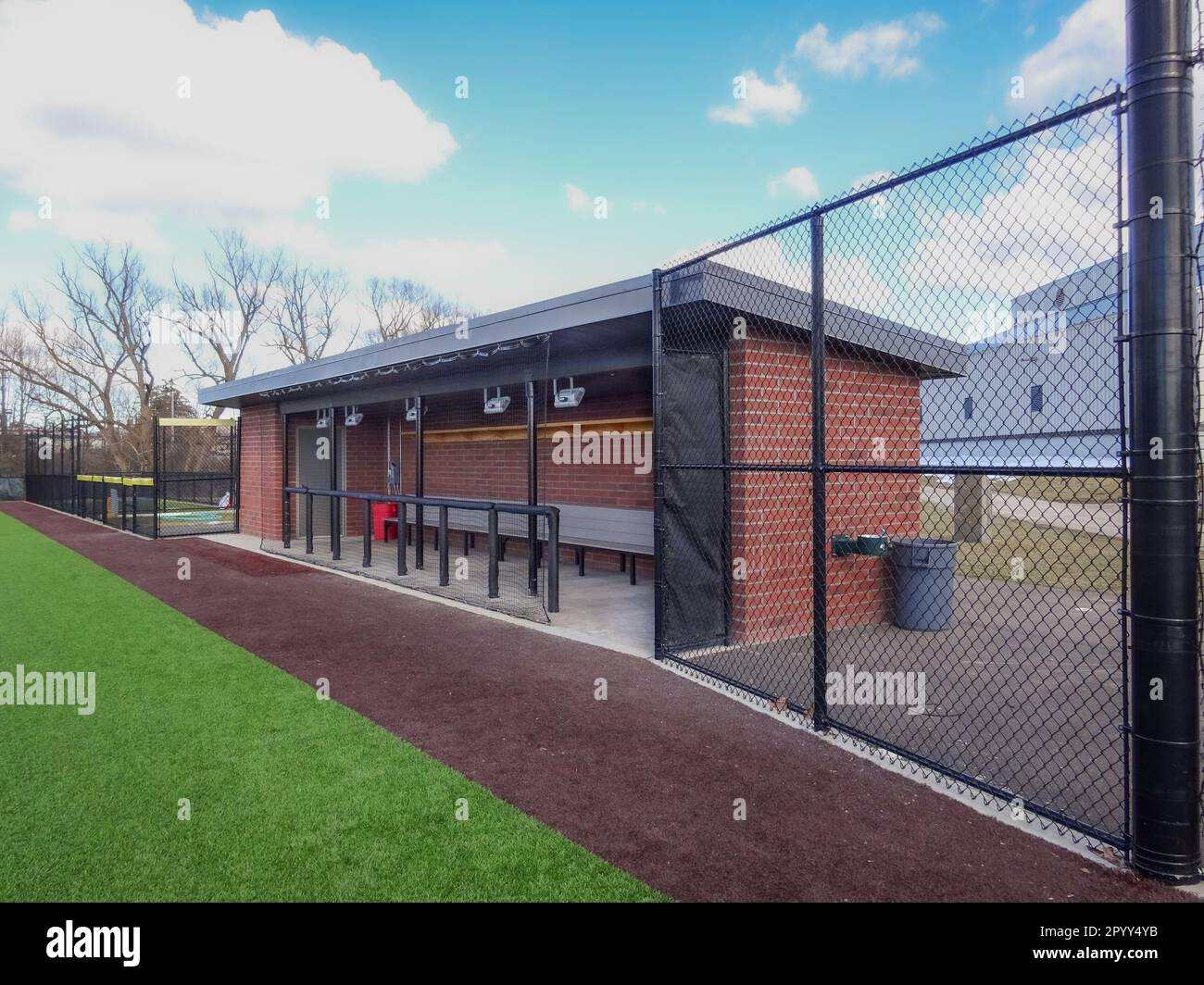 Brick baseball dugout with concrete floor benches and protective Brick baseball dugout with concrete floor benches and protective
