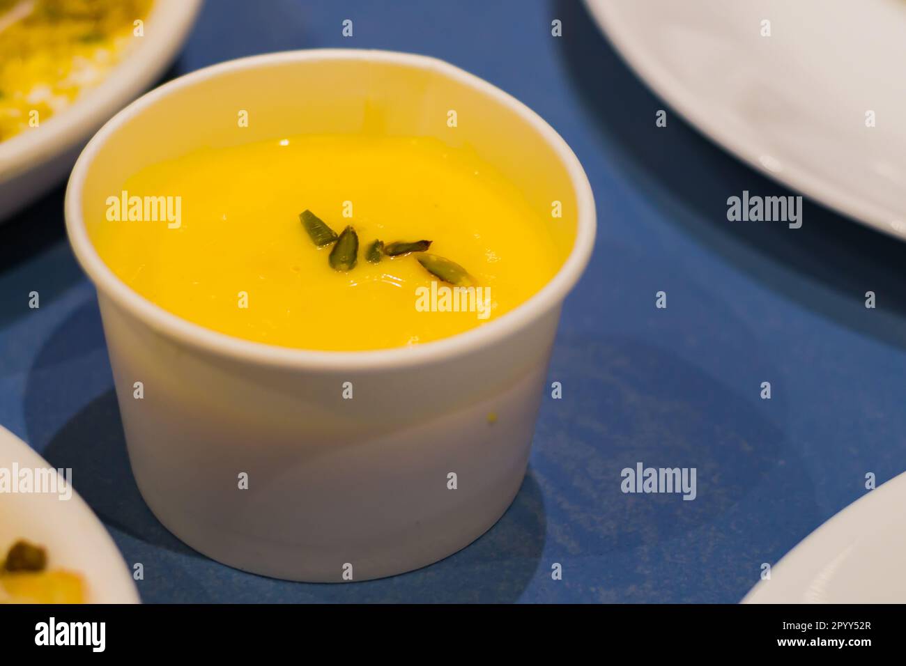 Shrikhand served in a paper cup. It is a traditional sweet in Gujarat