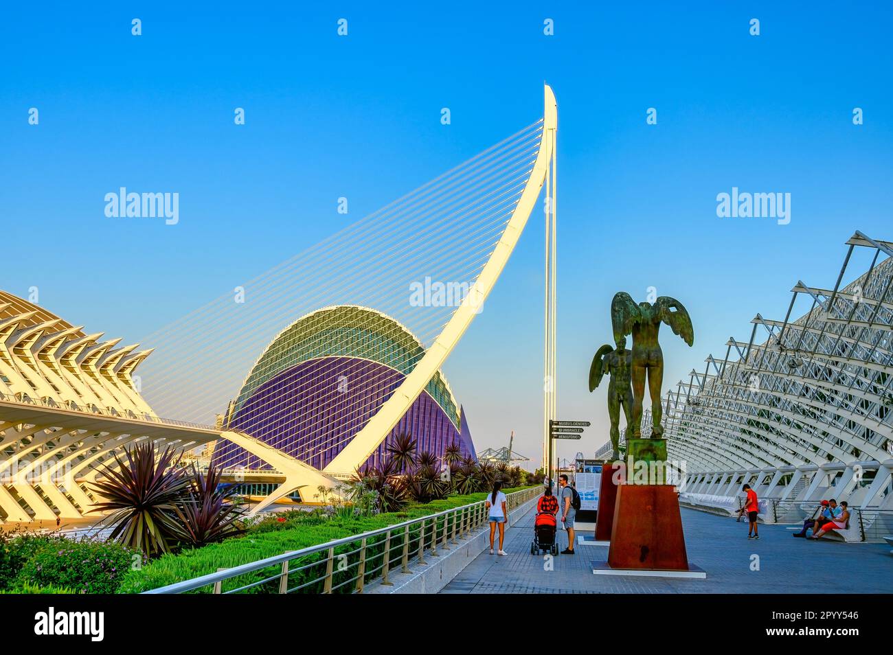 Valencia, Spain - July 17, 2022: Tourists sightseeing winged angles sculptures of bronze. The 'Ciutat de les Arts i les Ciències' was designed by Sant Stock Photo