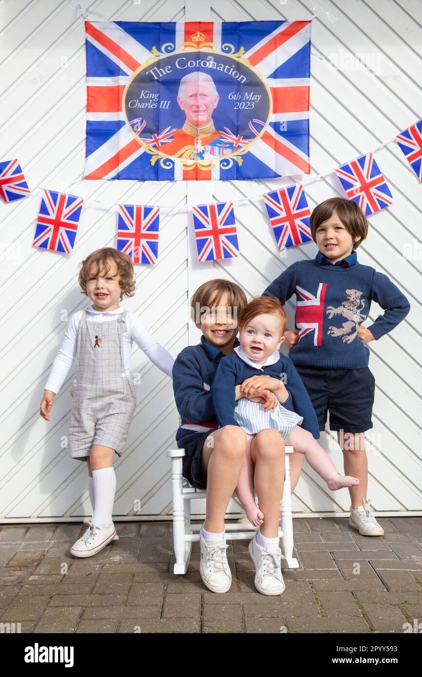 Halesowen, West Midlands, UK. 5th May, 2023. Four young excited brothers outside their family's