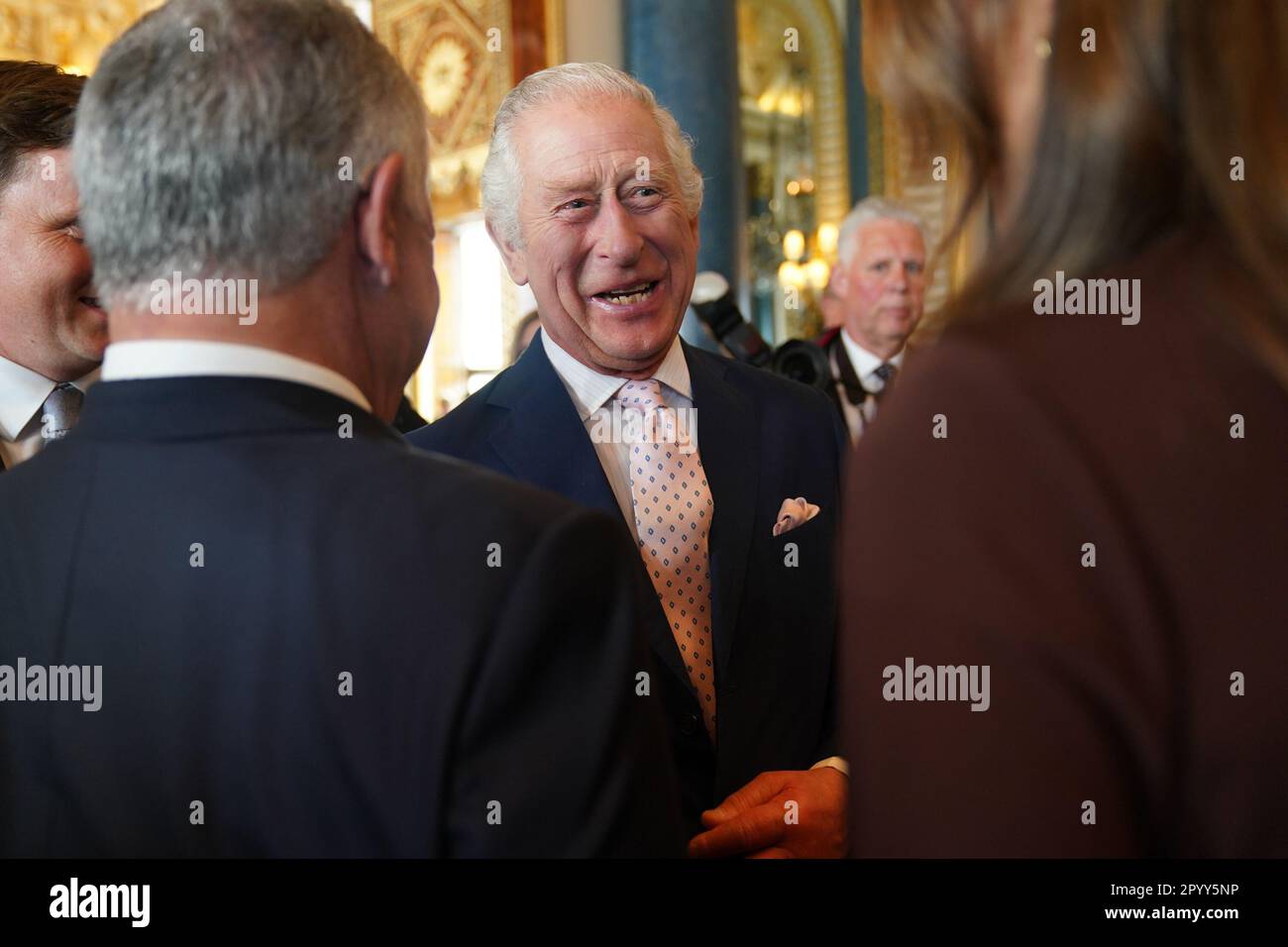 King Charles III speaks to guests during a reception at Buckingham Palace, in London, for overseas guests attending his coronation. Picture date: Friday May 5, 2023. Stock Photo